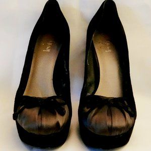 Well worn Levity brand black bow tie heel shoe